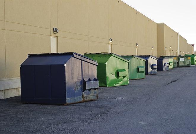 a row of industrial dumpsters for construction waste in Checotah